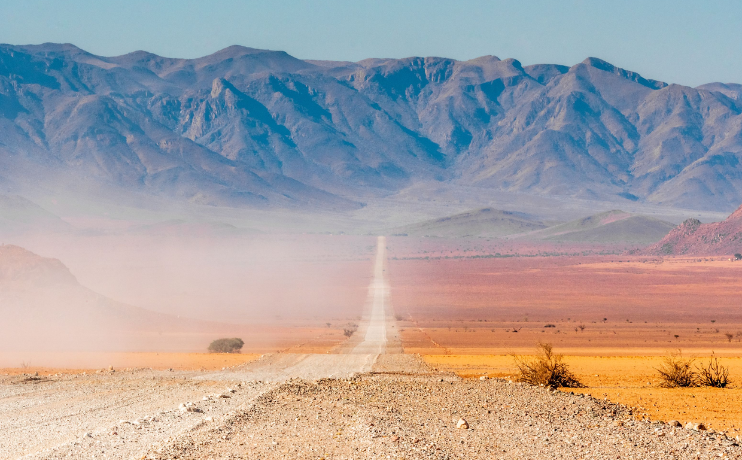 Namibia road with mountains of Namib desert - gay safari - gay travel - pivot trip - africa