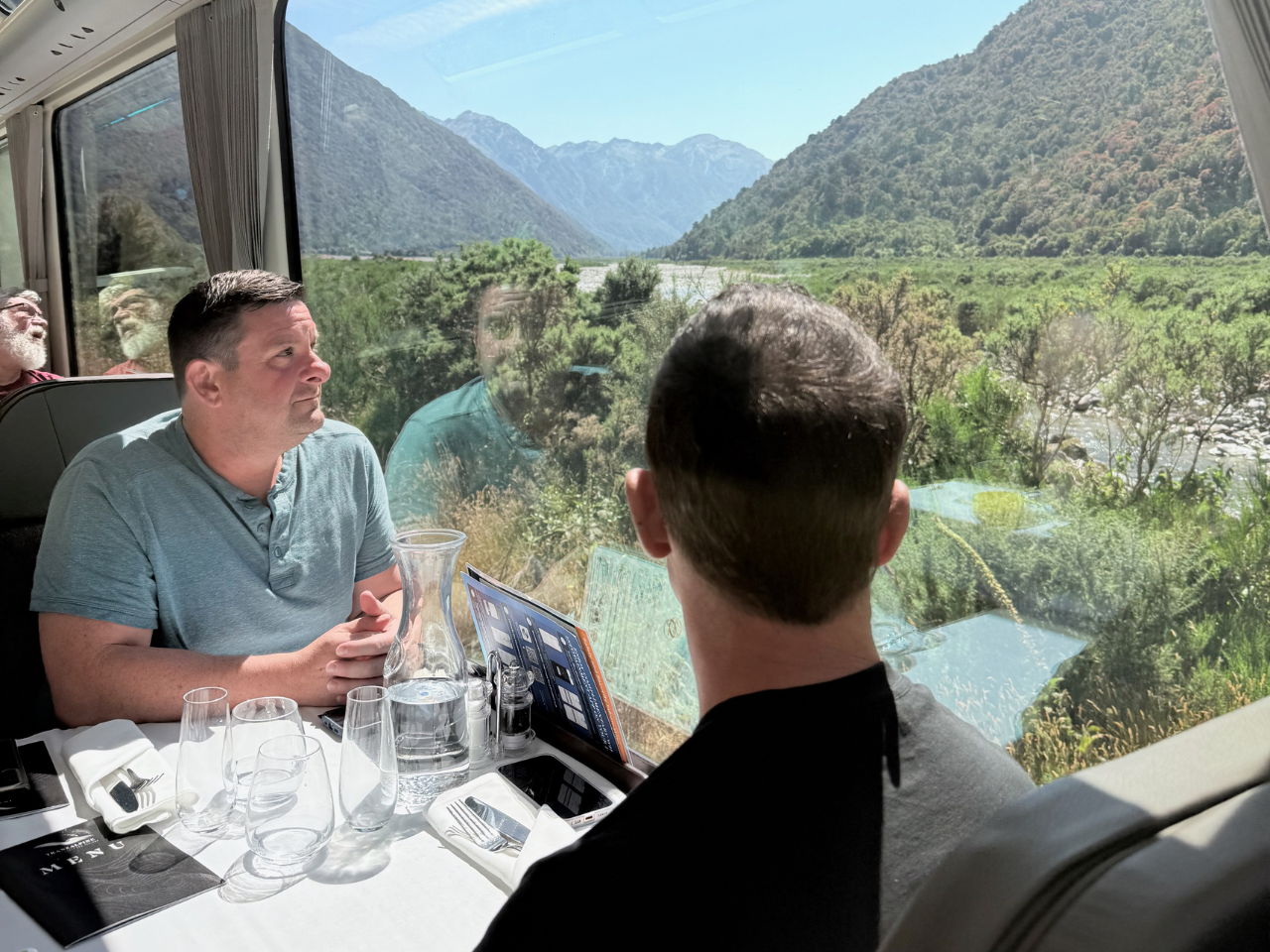 Pivot Trip small-group New Zealand tour for gay men — guys riding the TranzAlpine Railway