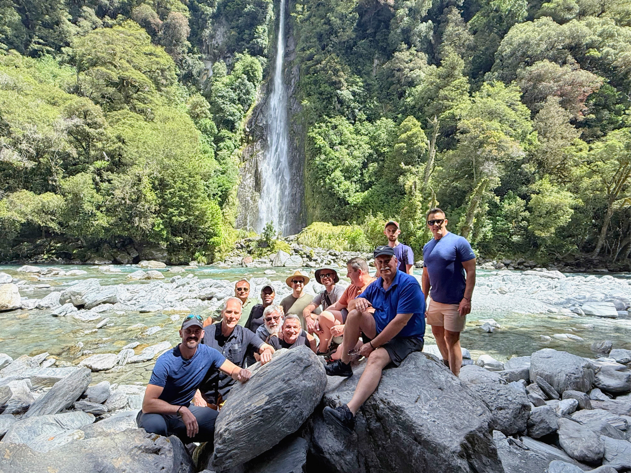 Pivot Trip small-group New Zealand tour for gay men — group picture in front of waterfall