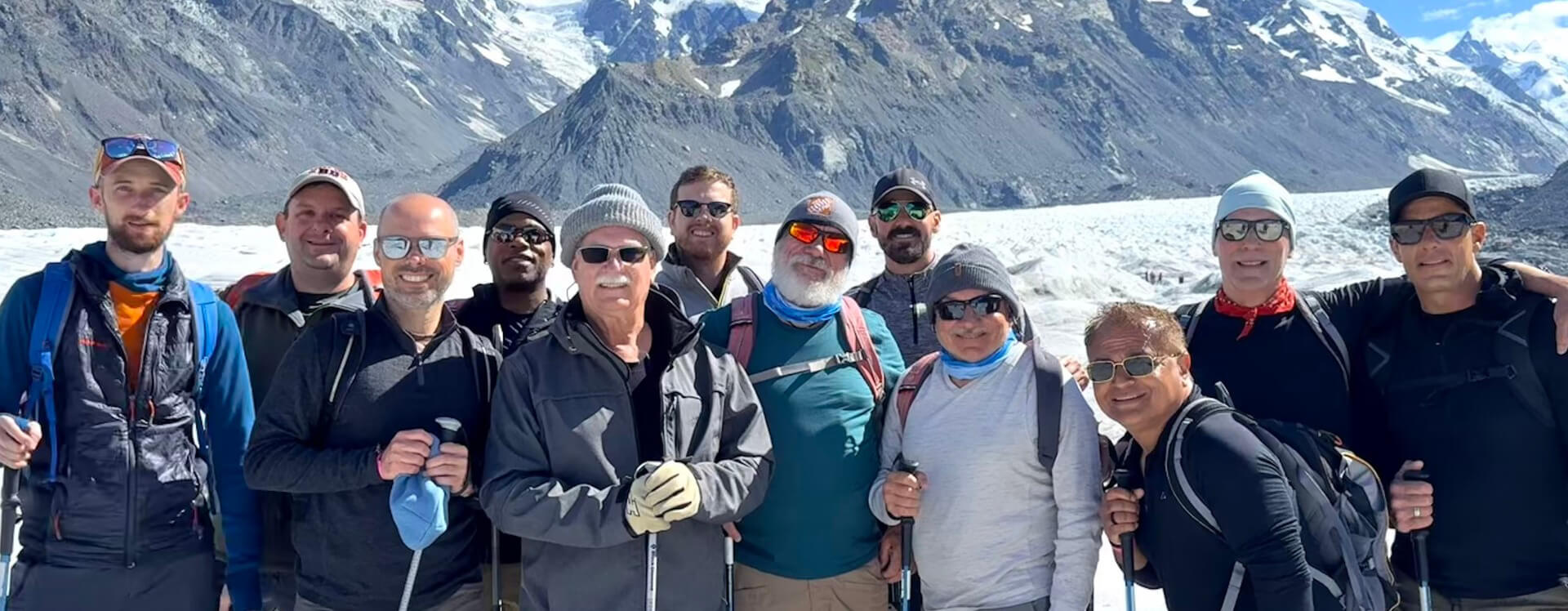 Group of Pivot Trip travelers in front of impressive mountains