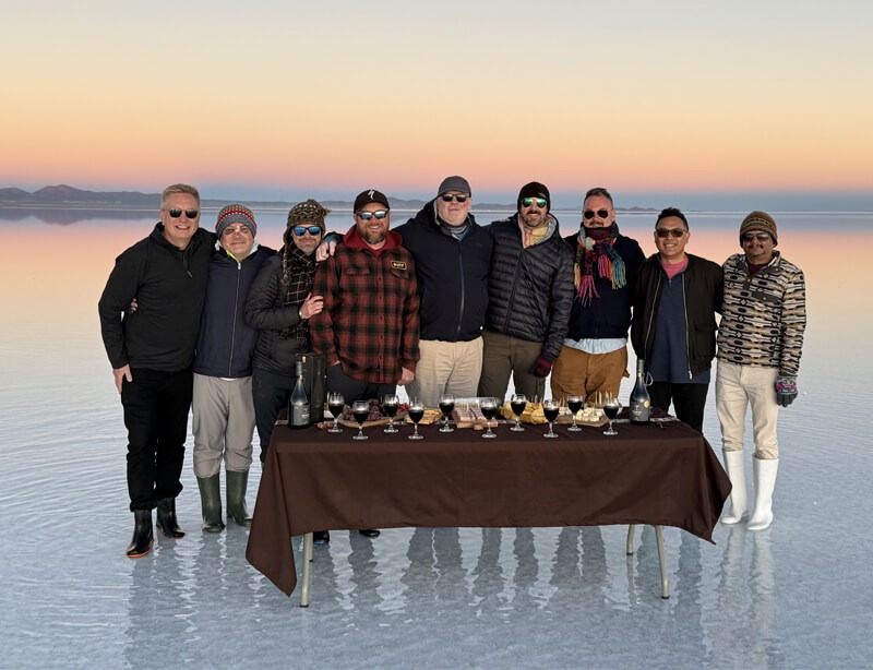 A group of gay men on a frozen lake on a Pivot Trip