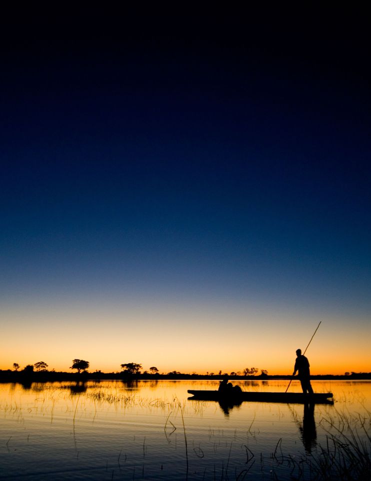 mokoro gliding through the Delta at golden hour in Botswana Okavango Delta Africa gay safari with Pivot Trip