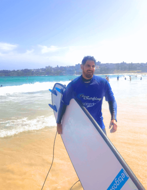 Pivot Trip small-group Australia tour for gay men gay travel — Cory Calvin Trip Leader in Bondi Beach surfing